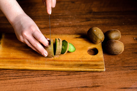 Sliced kiwi on a wooden boardの写真素材