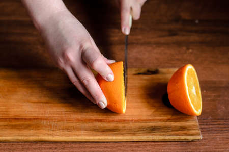 Sliced oranges on a wooden boardの写真素材