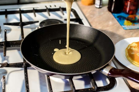 Cooking pancakes in a frying panの写真素材