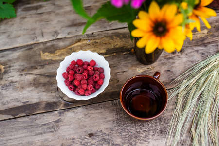 Still-life of flowers and baking with berries on a wooden table