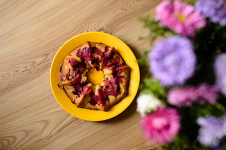 Apple pie and flowers on the table