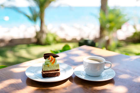 Coffee and dessert on the background of the sea.の写真素材