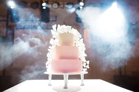 Beautiful birthday cake on the table from multiple tiersの写真素材