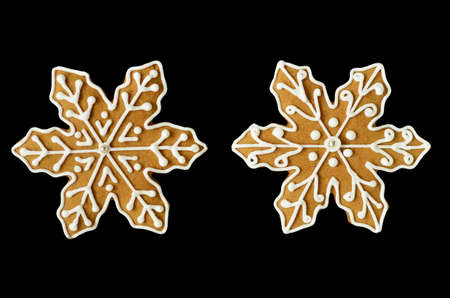 Gingerbread snowflake cookies isolated on black の写真素材