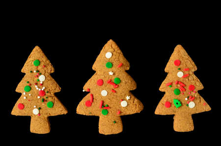 Gingerbread Christmas tree shaped cookies isolated on black の写真素材