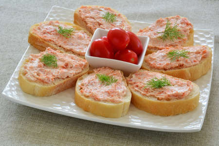 Smoked salmon and cream cheese on cibatta rounds appetizers in horizontal format. Shot in natural light.の写真素材