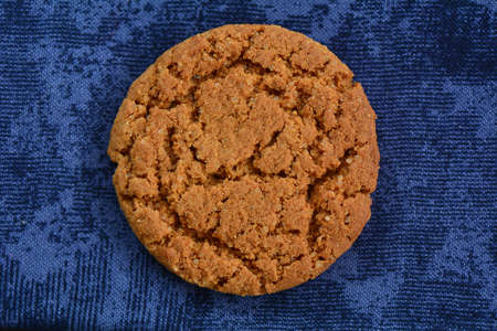 Fresh crunchy gingersnap closeup on dark blue background shot in natural lightの写真素材