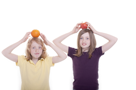 Two girls play with the fruitの写真素材