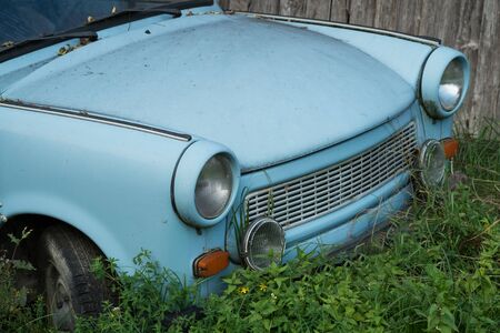 Old Eastern Europe GDR car is in the green meadow, blue oldtimer carの写真素材
