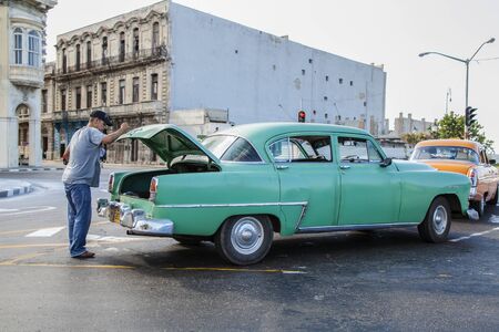 Havana, Cuba - 12 January 2013: The streets of Havana, very old American cars on the streets and a...