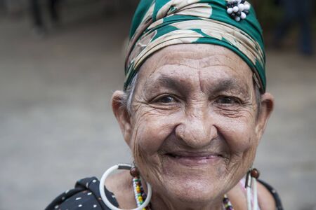 Havana, Cuba - 24 January 2013: Portraits of cuban people in traditional dresses. An elderly woman with the green headscarf.のeditorial素材