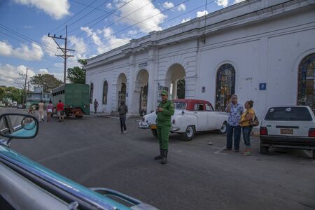 Havana, Cuba - 12 January 2013: A view of the streets of the city with cuban people. A man in military uniform standing in the street.のeditorial素材