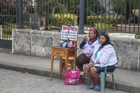 Havana, Cuba - 22 January 2013: A view of the streets of the city with cuban people. Two women sell cosmetics on the street.のeditorial素材