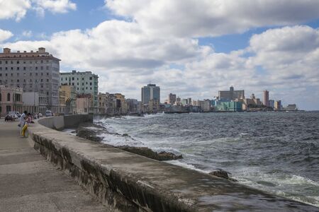Havana, Cuba - 22 January 2013: A view of the streets of the city with cuban people. A view of the city from the seawall malecon.のeditorial素材