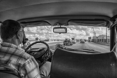 Havana, Cuba - 12 January 2013: Views of town center of squares and streets. A view from the back of the car on the street with malecon.のeditorial素材