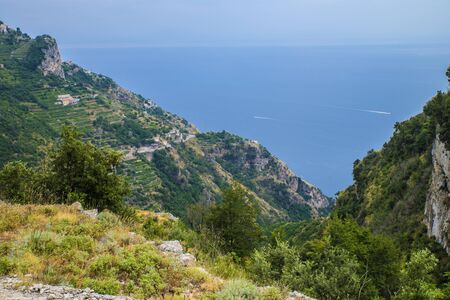 Naples, Positano Italy - August 12, 2015 : Hiking trail on the Amalfi Coast: "Sentiero degli dei" (God's way). A view from the trail down to the houses and sea.のeditorial素材