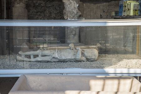 POMPEII, ITALY - 8 August 2015: Ruins of antique roman temple in Pompeii near volcano Vesuvius, Naples, Italy. A trace of a corpse of the citizens of Pompeiiのeditorial素材
