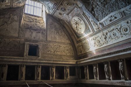 POMPEII, ITALY - 8 August 2015: Ruins of antique roman temple in Pompeii near volcano Vesuvius, Naples, Italy. A view into the interior of a building of the city of Popmpeii with frescoes on the wall.のeditorial素材