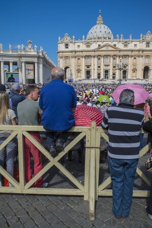 Vatican - June 18, 2014 : Pilgrims come to visit St. Peter's Square in Vatican. Pilgrims in the foreground and a Pope Francis stands on the podium.のeditorial素材