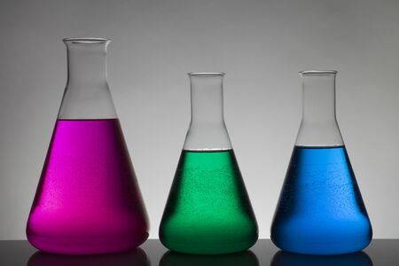 Liquid in laboratory bottles. Scientific biochemical laboratory. Colorful liquid. Isolated on white background,  a group of bottles. Test tubes.の写真素材