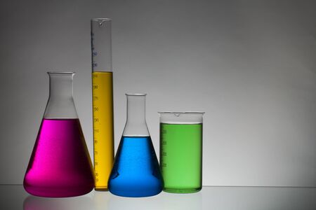 Liquid in laboratory bottles. Scientific biochemical laboratory. Colorful liquid. Isolated on white...