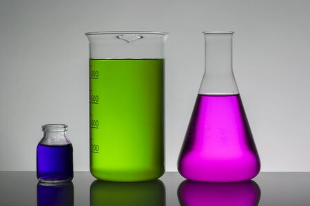 Liquid in laboratory bottles. Scientific biochemical laboratory. Colorful liquid. Isolated on white background,  a group of bottles. Test tubes.の写真素材