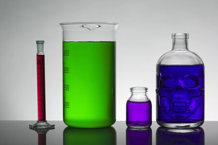 Liquid in laboratory bottles. Scientific biochemical laboratory. Colorful liquid. Isolated on white background,  a group of bottles. Test tubes.の写真素材
