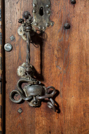 ornately decorated medieval wooden door, photographed in a german church, schwaebisch hall