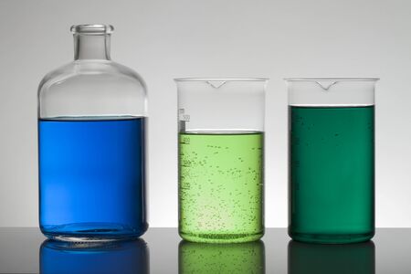 Liquid in laboratory bottles. Scientific biochemical laboratory. Colorful liquid. Isolated on white background,  a group of bottles. Test tubes.の写真素材