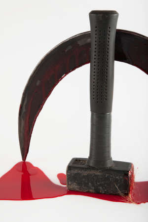 Hammer and sickle smeared with blood, on a white background. Visual description of a totalitarian state.の写真素材