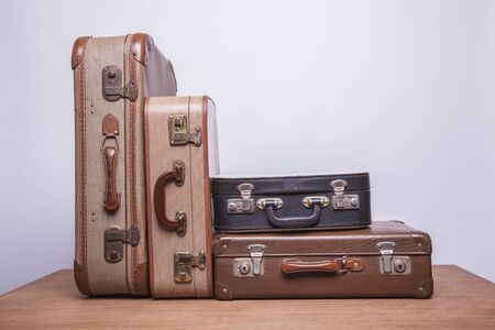 Old, retro, suitcases lie on the table with white background. Obsolete suitcase.の写真素材