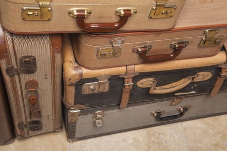 Old, retro, suitcases lie on the table with white background. Obsolete suitcase lying on the floorの写真素材