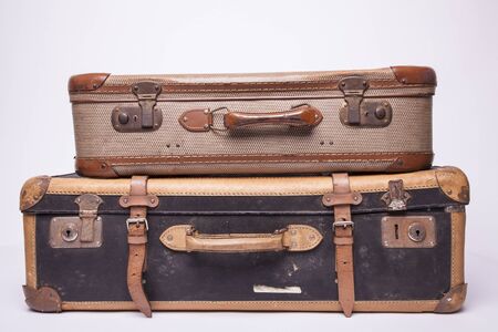Old, retro, suitcases lie on the table with white background. Obsolete suitcase isolated on white...