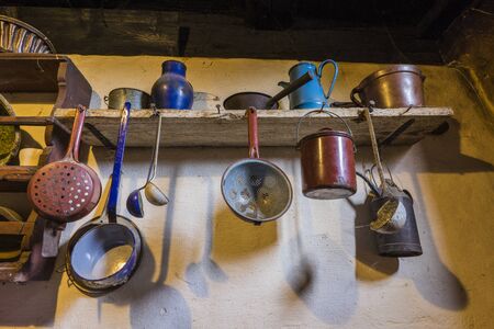 Bad Windsheim, Germany - 16 October 2019: Interior views of a german village house. View of an old, antique kitchen table with pots, plates and kitchen utensilsのeditorial素材
