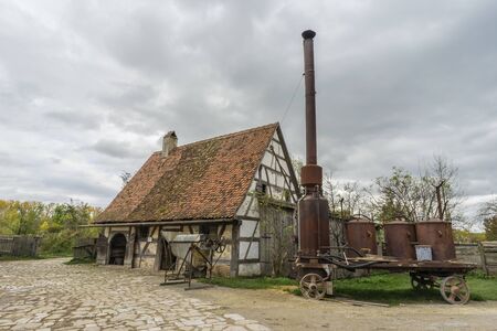 Bad Windsheim, Germany - 16 October 2019: View from a half timbered house in a german village.  View  an antique farm with must distillerのeditorial素材