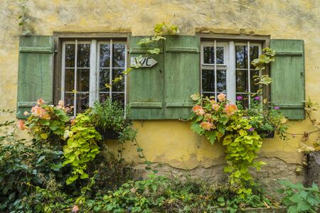 Bad Windsheim, Germany - 16 October 2019: View on a window with autumnal flowers, romantic autumn. Ancient German villages.のeditorial素材