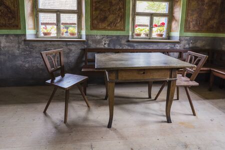 Bad Windsheim, Germany - 16 October 2019: Interior views of a german village house. View from an old rustic wooden dining table, chairs and benchesのeditorial素材