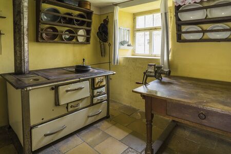 Bad Windsheim, Germany - 16 October 2019: Interior views of a german village house. View of an old, antique kitchen stove and a table with a meat grinderのeditorial素材