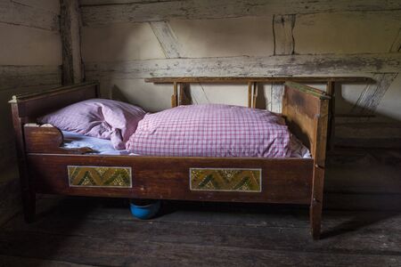 Bad Windsheim, Germany - 16 October 2019: Interior views of a german village house. View into the rural bedroom with  antique bed, chamber potのeditorial素材