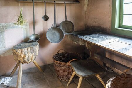 Schwaebisch Hall, Wackershofen, Germany - 15 October 2019: Interior views of a german village house. View of an old, antique kitchen table with pots and frying pansのeditorial素材