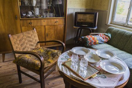 Schwaebisch Hall, Wackershofen, Germany - 15 October 2019: Interior views of a german village house. View into the rustic living room with armchair and a coffee tableのeditorial素材