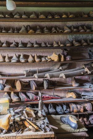 Schwaebisch Hall, Wackershofen, Germany - 15 October 2019: View into a shoemakers workshop with many...