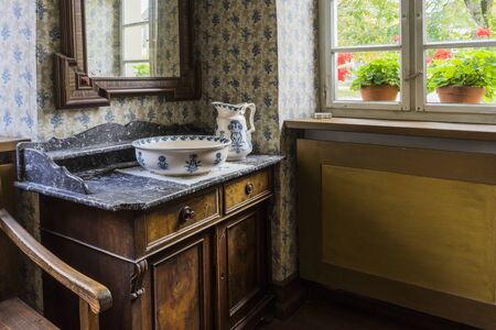 Schwaebisch Hall, Wackershofen, Germany - 15 October 2019: Interior views of a german village house. View in a german peasant bedroom with wash bowl on dresserのeditorial素材