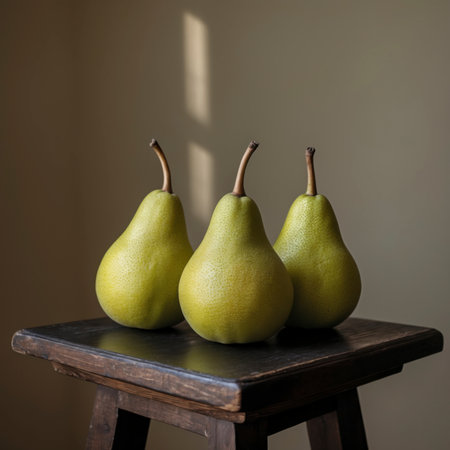 Pears rest on an old wooden table in front of a dark, painterly background. The scene feels classic and reminiscent of traditional still life.の素材