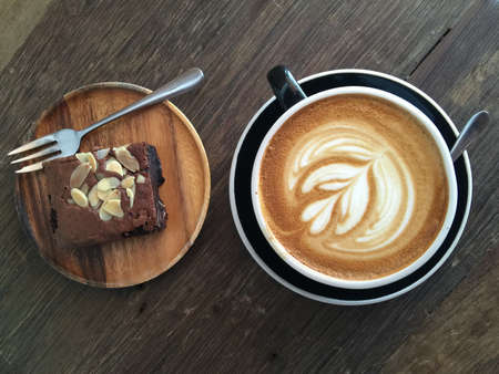 Cup of latte coffee with brownie cakeの写真素材