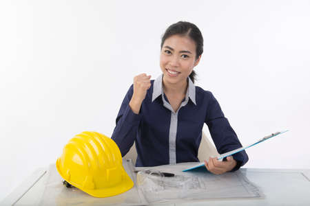 pretty asian Woman construction worker on working table