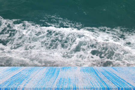 blue wood table top on blur ocean