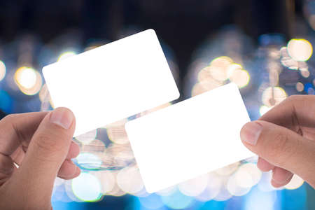 two hand hold blank card over beautuful backgroundの写真素材
