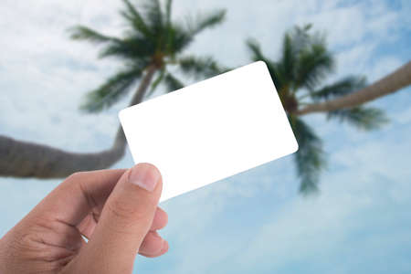 hand hold blank card over beach backgroundの写真素材
