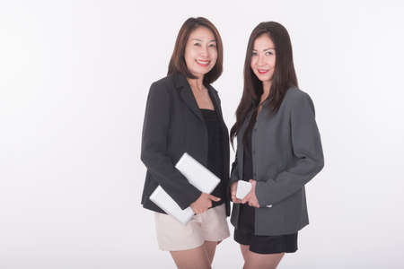 two asian woman with tablet and smart phoneの写真素材